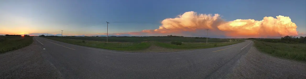 Sunset storm clouds over the prairie road, 2017