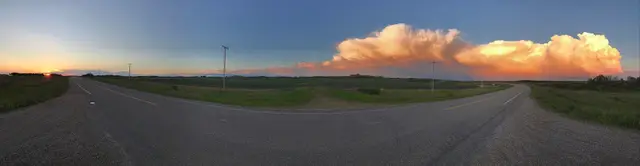 Sunset storm clouds over the prairie road